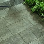Eikon Exterior tile in the finish Titanio used in a garden with exterior furniture