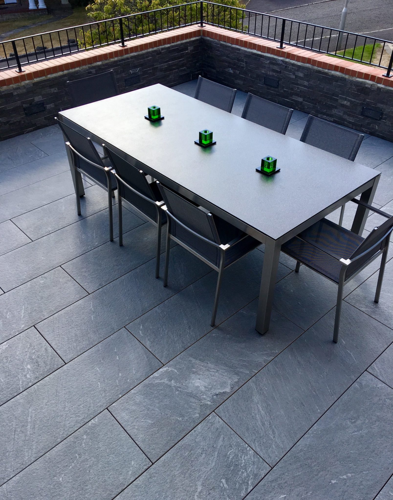 Outdoor furniture on raised grey porcelain tile terrace