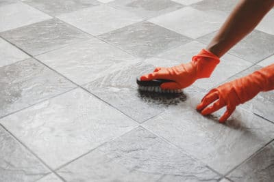 cleaning tiles with a brush